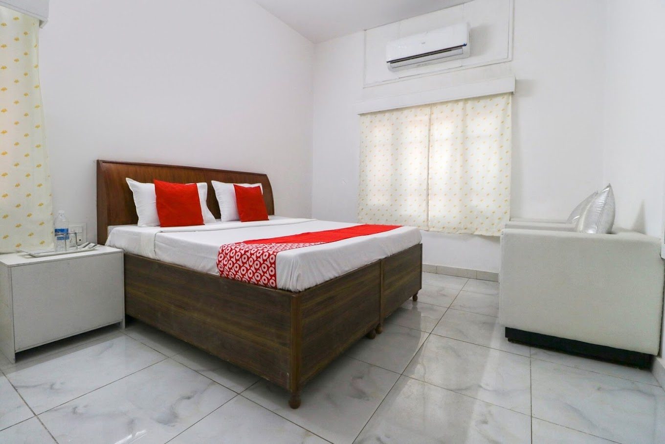 Air-conditioned guest room with double bed and marble flooring